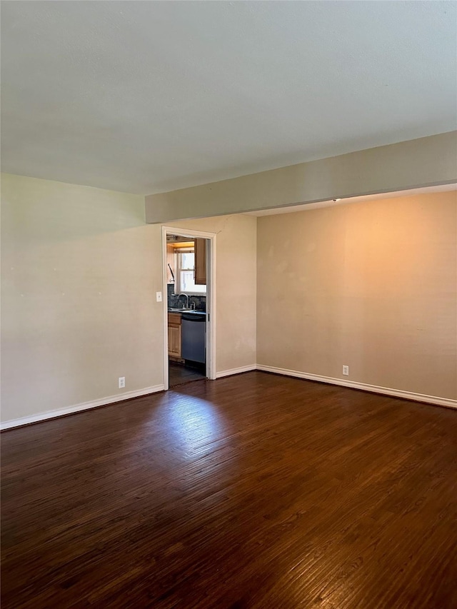 2952 Eric Ln, Farmers Branch, TX 75234 - spare room with dark wood-type flooring, baseboards, and a sink