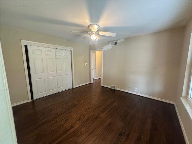 2952 Eric Ln, Farmers Branch, TX 75234 - unfurnished bedroom with dark wood finished floors, a closet, baseboards, and ceiling fan