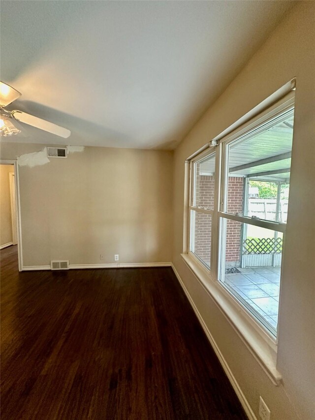 2952 Eric Ln, Farmers Branch, TX 75234 - spare room with dark wood finished floors, a ceiling fan, and baseboards