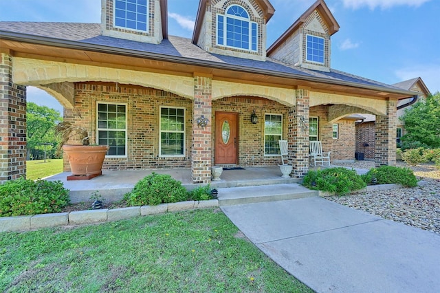 5300 Highland Dr, Denison, TX 75020 - view of front facade featuring a porch, brick siding, and roof with shingles