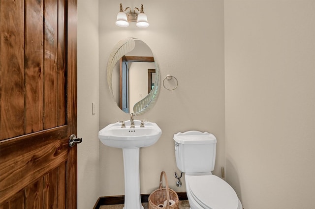 5300 Highland Dr, Denison, TX 75020 - half bath with toilet, a sink, and baseboards