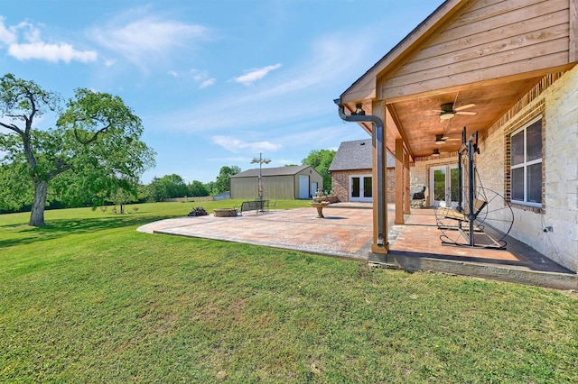 5300 Highland Dr, Denison, TX 75020 - view of green lawn with french doors, an outdoor structure, a patio, and a ceiling fan