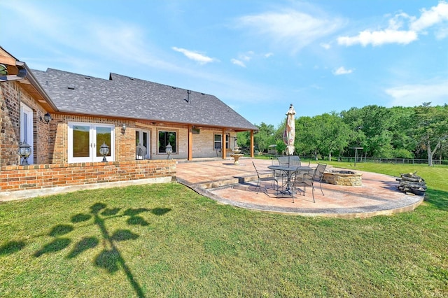 5300 Highland Dr, Denison, TX 75020 - back of property featuring a fire pit, a patio area, brick siding, and roof with shingles