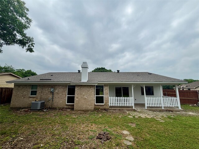 1153 Tracy Ln, Lancaster, TX 75134 - back of property with central AC unit, brick siding, a chimney, and roof with shingles