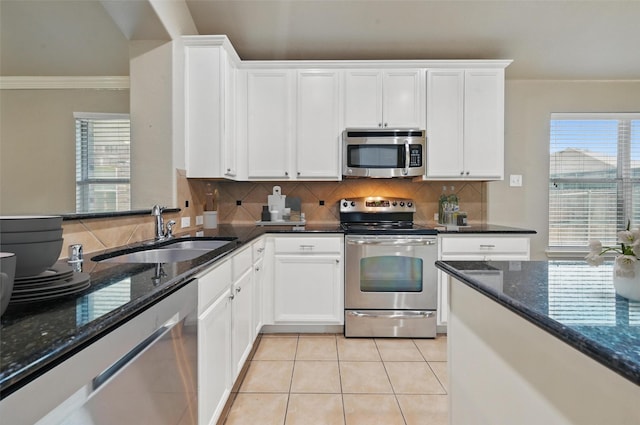 2020 Childress Dr, Forney, TX 75126 - kitchen with appliances with stainless steel finishes, a sink, backsplash, dark stone countertops, and white cabinets