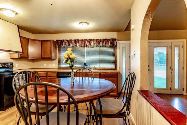 2606 Cedar Elm Ln, Garland, TX 75043 - dining space featuring light wood-style flooring and a textured wall