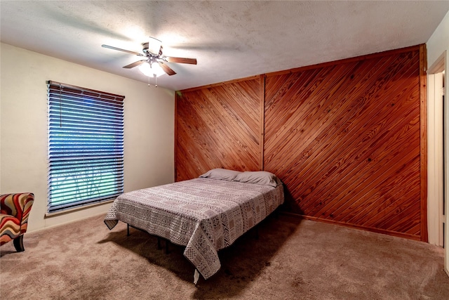 2606 Cedar Elm Ln, Garland, TX 75043 - carpeted bedroom featuring wooden walls and ceiling fan