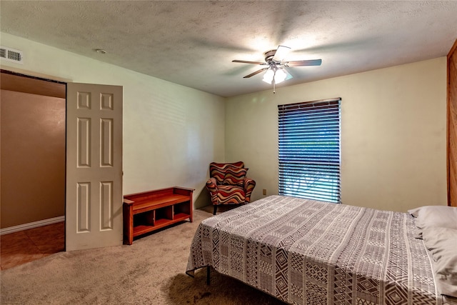 2606 Cedar Elm Ln, Garland, TX 75043 - carpeted bedroom with a textured ceiling and ceiling fan