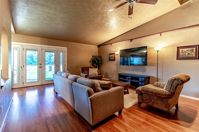 2606 Cedar Elm Ln, Garland, TX 75043 - living room featuring wood finished floors, lofted ceiling, ceiling fan, french doors, and a textured ceiling