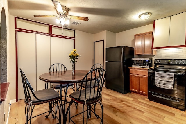 2606 Cedar Elm Ln, Garland, TX 75043 - kitchen with black appliances, ceiling fan, light wood-style floors, decorative backsplash, and brown cabinets