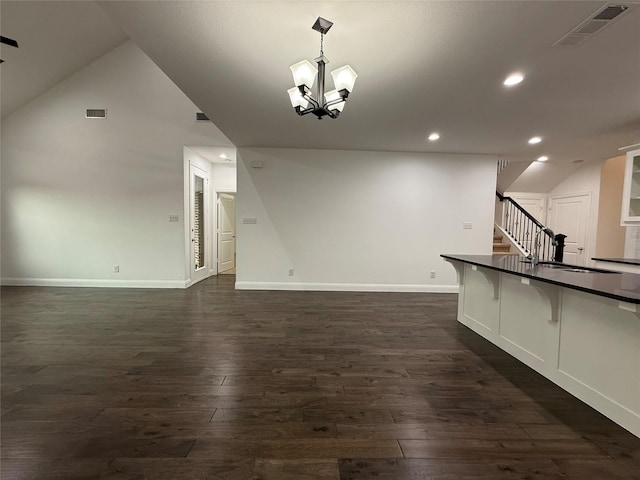 1103 Bantham Way, Forney, TX 75126 - kitchen with dark countertops, dark wood-style flooring, open floor plan, a breakfast bar area, and recessed lighting