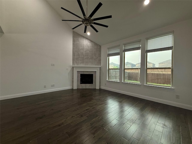 1103 Bantham Way, Forney, TX 75126 - unfurnished living room with vaulted ceiling, a ceiling fan, dark wood-style flooring, baseboards, and a tile fireplace