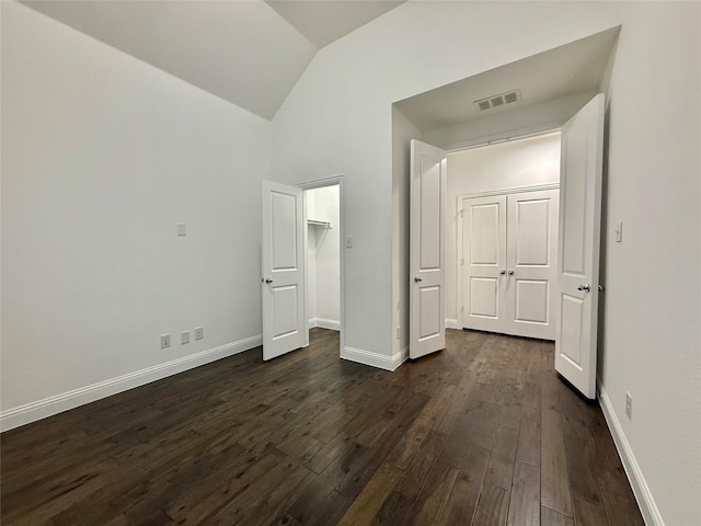 1103 Bantham Way, Forney, TX 75126 - unfurnished bedroom featuring dark wood-type flooring, lofted ceiling, baseboards, a spacious closet, and a closet