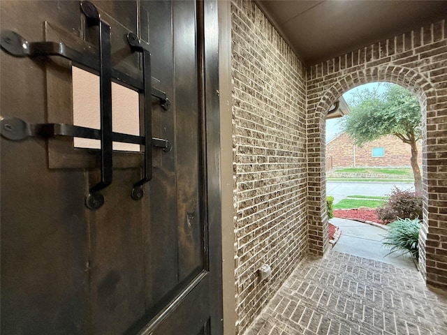 1103 Bantham Way, Forney, TX 75126 - doorway to outside featuring brick wall and brick patterned flooring