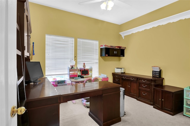 office area featuring light carpet and a ceiling fan