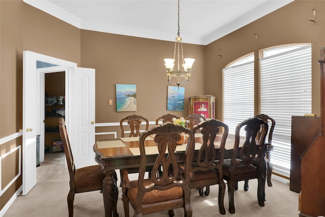 dining area featuring light colored carpet, a chandelier, and ornamental molding