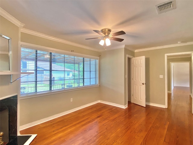 unfurnished living room with wood finished floors, ceiling fan, baseboards, and ornamental molding