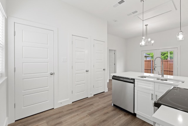 607 W Sears St, Denison, TX 75020 - kitchen featuring stainless steel dishwasher, a sink, light wood-style floors, white cabinets, and pendant lighting
