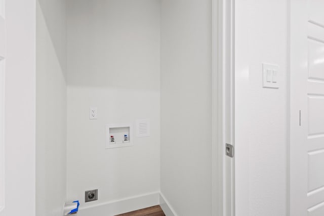 607 W Sears St, Denison, TX 75020 - washroom with hookup for a washing machine, electric dryer hookup, dark wood finished floors, and baseboards