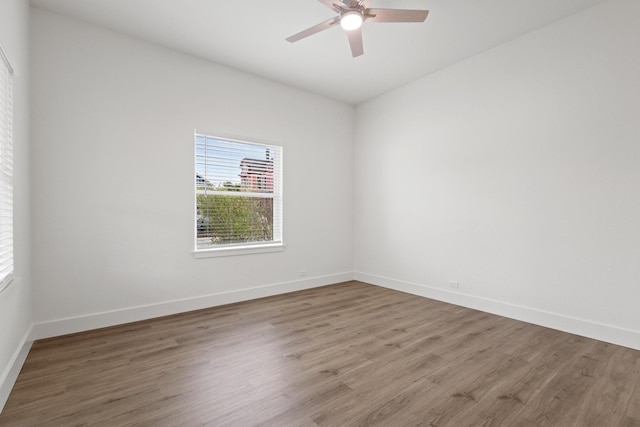 607 W Sears St, Denison, TX 75020 - empty room with wood finished floors, ceiling fan, and baseboards