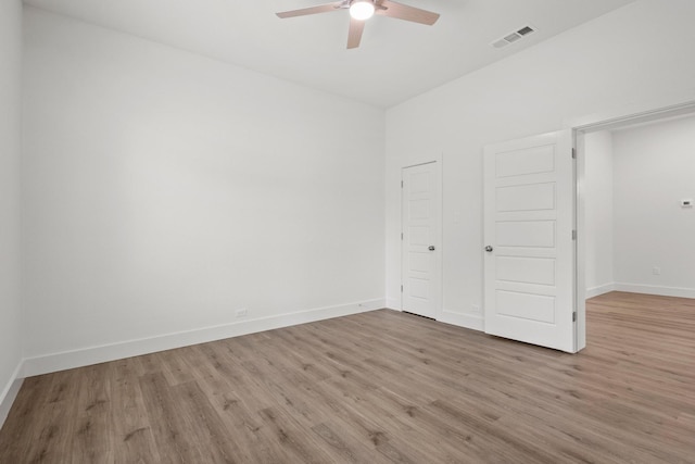 607 W Sears St, Denison, TX 75020 - unfurnished bedroom featuring wood finished floors, baseboards, and ceiling fan
