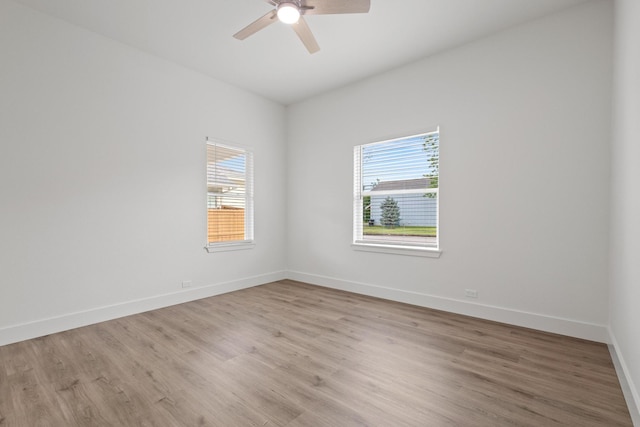 607 W Sears St, Denison, TX 75020 - spare room featuring healthy amount of natural light, ceiling fan, light wood-type flooring, and baseboards