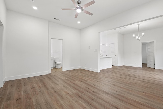 607 W Sears St, Denison, TX 75020 - unfurnished living room featuring ceiling fan, light wood finished floors, a chandelier, recessed lighting, and baseboards