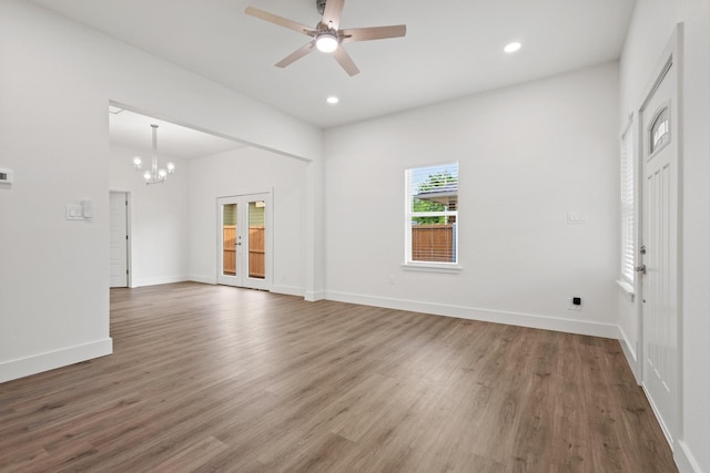 607 W Sears St, Denison, TX 75020 - unfurnished living room with a chandelier, wood finished floors, ceiling fan, baseboards, and recessed lighting