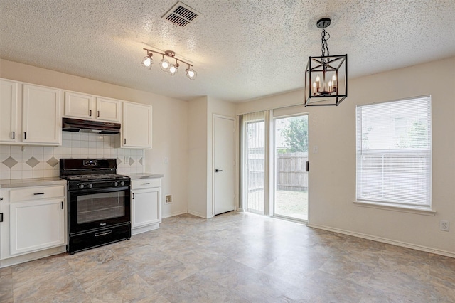 914 Gillon Dr, Arlington, TX 76001 - kitchen with black gas range, under cabinet range hood, decorative backsplash, white cabinets, and a textured ceiling