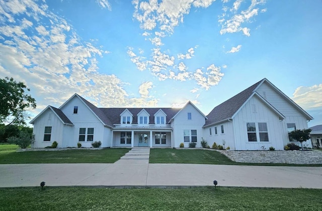 1926 N Stodghill Rd, Rockwall, TX 75087 - view of front of house with board and batten siding, a front yard, and covered porch