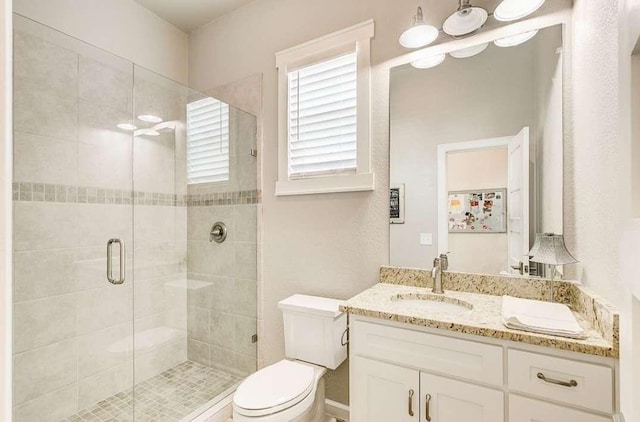 1926 N Stodghill Rd, Rockwall, TX 75087 - bathroom featuring toilet, vanity, and a shower stall
