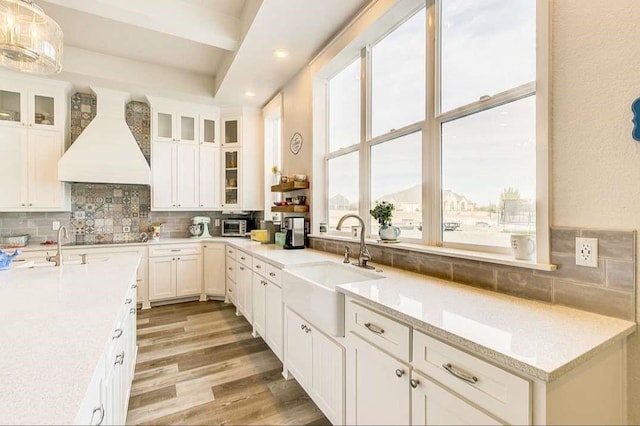 1926 N Stodghill Rd, Rockwall, TX 75087 - kitchen featuring a sink, custom exhaust hood, decorative backsplash, white cabinets, and recessed lighting