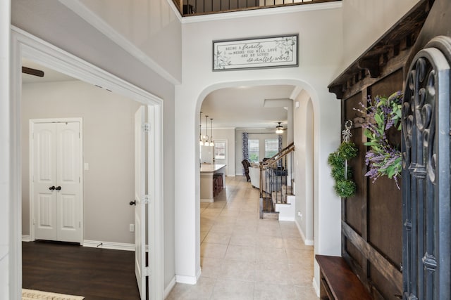 7745 Northumberland Dr, Fort Worth, TX 76179 - foyer with arched walkways, ceiling fan, stairs, baseboards, and light tile patterned flooring