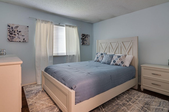 6713 Windwillow Dr, Fort Worth, TX 76137 - bedroom featuring a textured ceiling and dark wood-style floors