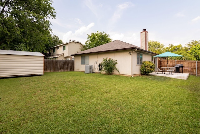 6713 Windwillow Dr, Fort Worth, TX 76137 - back of property featuring a patio area, a chimney, an outdoor structure, cooling unit, and a shed