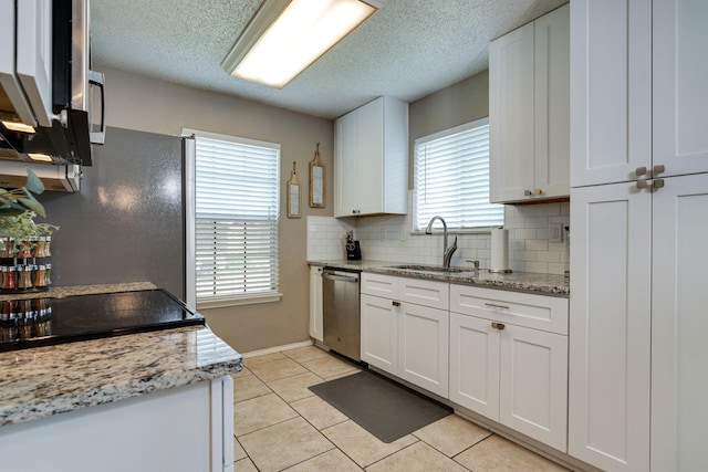 6713 Windwillow Dr, Fort Worth, TX 76137 - kitchen with a sink, stainless steel dishwasher, white cabinets, decorative backsplash, and light tile patterned floors