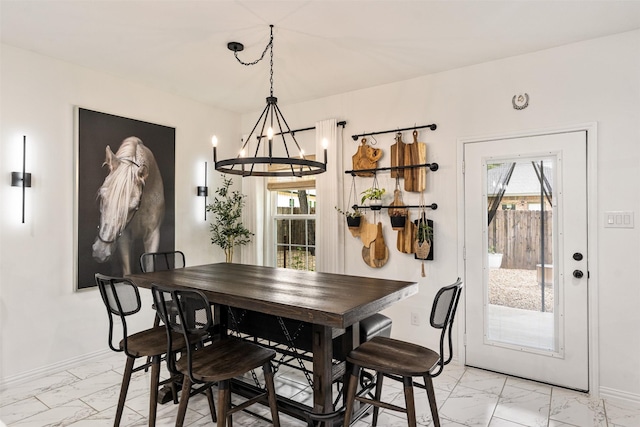 1096 Tupuna Ct, Tool, TX 75143 - dining space featuring light marble finish flooring, a chandelier, baseboards, and healthy amount of natural light