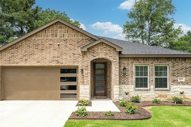 1096 Tupuna Ct, Tool, TX 75143 - french provincial home featuring roof with shingles, a garage, brick siding, concrete driveway, and stone siding
