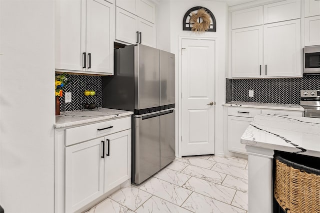 1096 Tupuna Ct, Tool, TX 75143 - kitchen featuring stainless steel appliances, light marble finish floors, white cabinetry, and tasteful backsplash