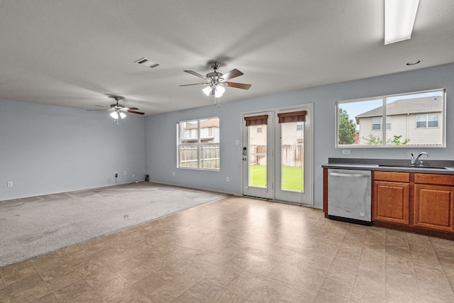 8532 Star Thistle Dr, Fort Worth, TX 76179 - kitchen with stainless steel dishwasher, light flooring, a sink, ceiling fan, and brown cabinets