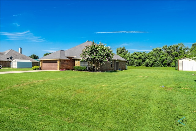 10195 Angie Ave, Eustace, TX 75124 - view of front of house featuring a storage shed, concrete driveway, a garage, a front yard, and an outbuilding