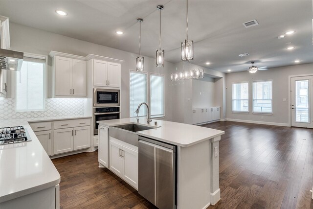 8230 Callimont Ln, Dallas, TX 75231 - kitchen with stainless steel appliances, a sink, light countertops, ceiling fan, and recessed lighting