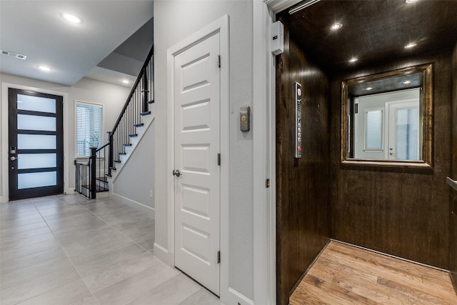 8230 Callimont Ln, Dallas, TX 75231 - foyer entrance with elevator, baseboards, stairs, light tile patterned floors, and recessed lighting