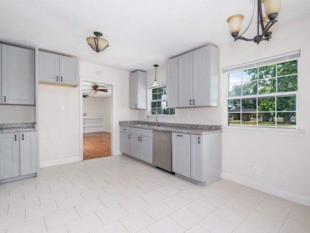 1803 4th St, Brownwood, TX 76801 - kitchen with dishwasher, a sink, baseboards, and ceiling fan