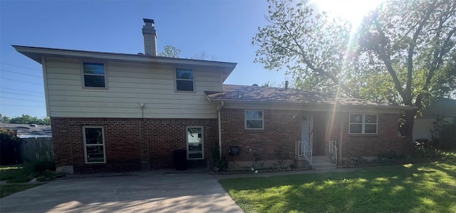 5708 Melinda St, Haltom City, TX 76117 - rear view of house with brick siding, a lawn, and a chimney