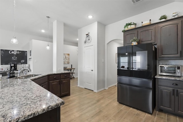 725 Sandy Chip Trl, Fort Worth, TX 76108 - kitchen with smart refrigerator, a sink, dark brown cabinets, light wood-style flooring, and light stone countertops