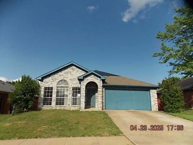 6107 Brookfall Dr, Arlington, TX 76018 - view of front facade with a garage, concrete driveway, and a front lawn