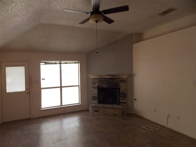 6107 Brookfall Dr, Arlington, TX 76018 - unfurnished living room with vaulted ceiling, ceiling fan, a fireplace with raised hearth, and a textured ceiling