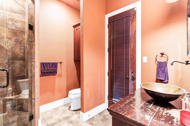 620 Timber Creek Cir, Stephenville, TX 76401 - full bathroom featuring a shower stall, toilet, baseboards, vanity, and tile patterned flooring