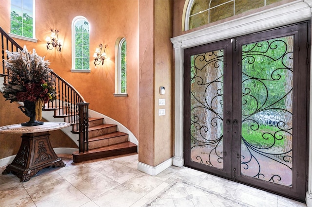 620 Timber Creek Cir, Stephenville, TX 76401 - entryway with french doors, stairway, baseboards, and a towering ceiling